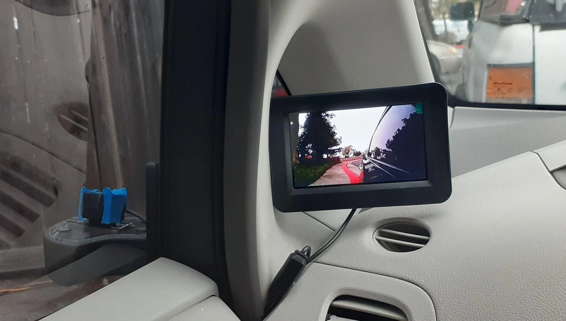 Cybercab Robotaxi camera side mirror on leaf 20210126_183614